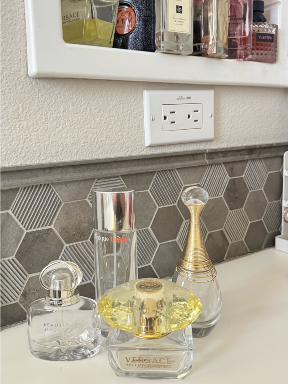 Dior (not clearly pictured) Assorted Clear and Gold-Accented Perfume Bottles